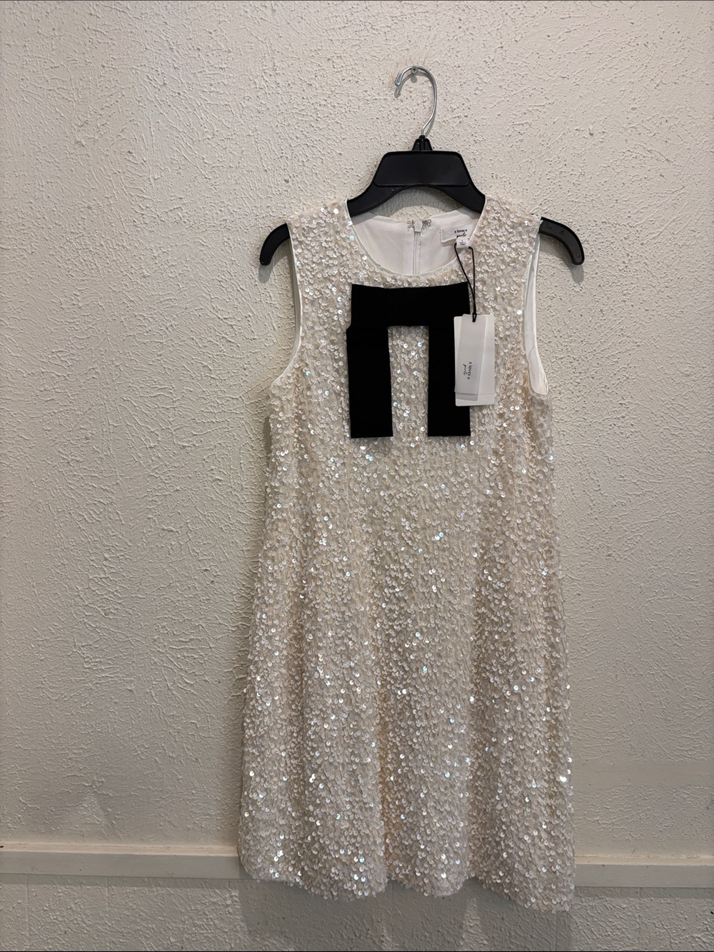 Girls' Ivory Sequin A-Line Dress with Black Bow Accent
